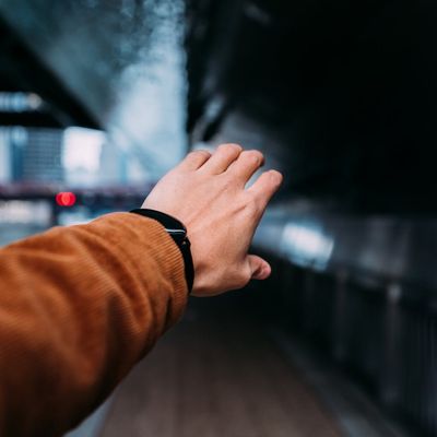 Blurred motion of hands reaching for the sky